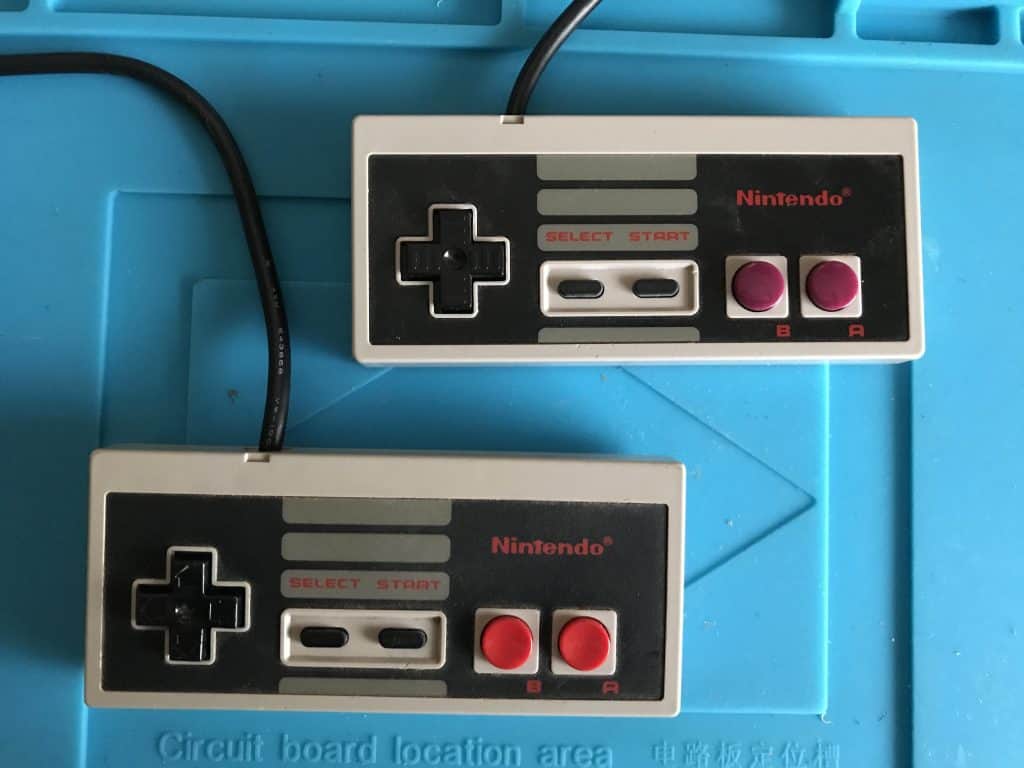 Two NES pads. One modded, one original.